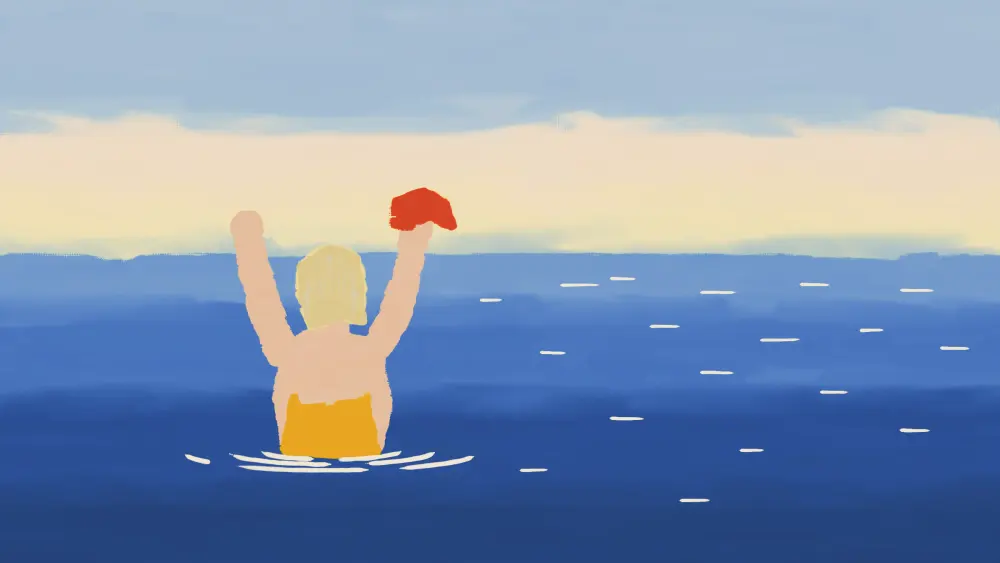 A blonde woman wading into a cold blue sea, arms up, swim cap in her hand.