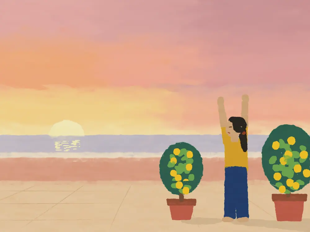 A woman stretching her arms up on a terrace at sunrise between two lemon trees.