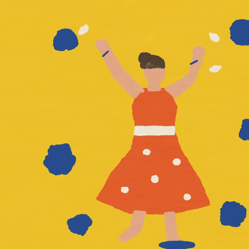 A woman in a red polka-dot dress dancing with her arms up on a yellow ground.